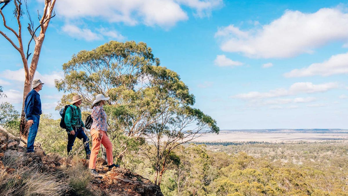 Boobook Explore guests looking over a valley from Mount Abundance, Outback Queensland