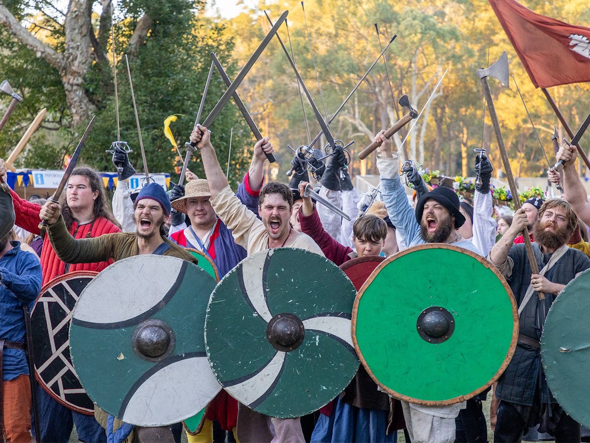 Viking shields are protecting and swords are drawn in anglo-saxon combat demonstration