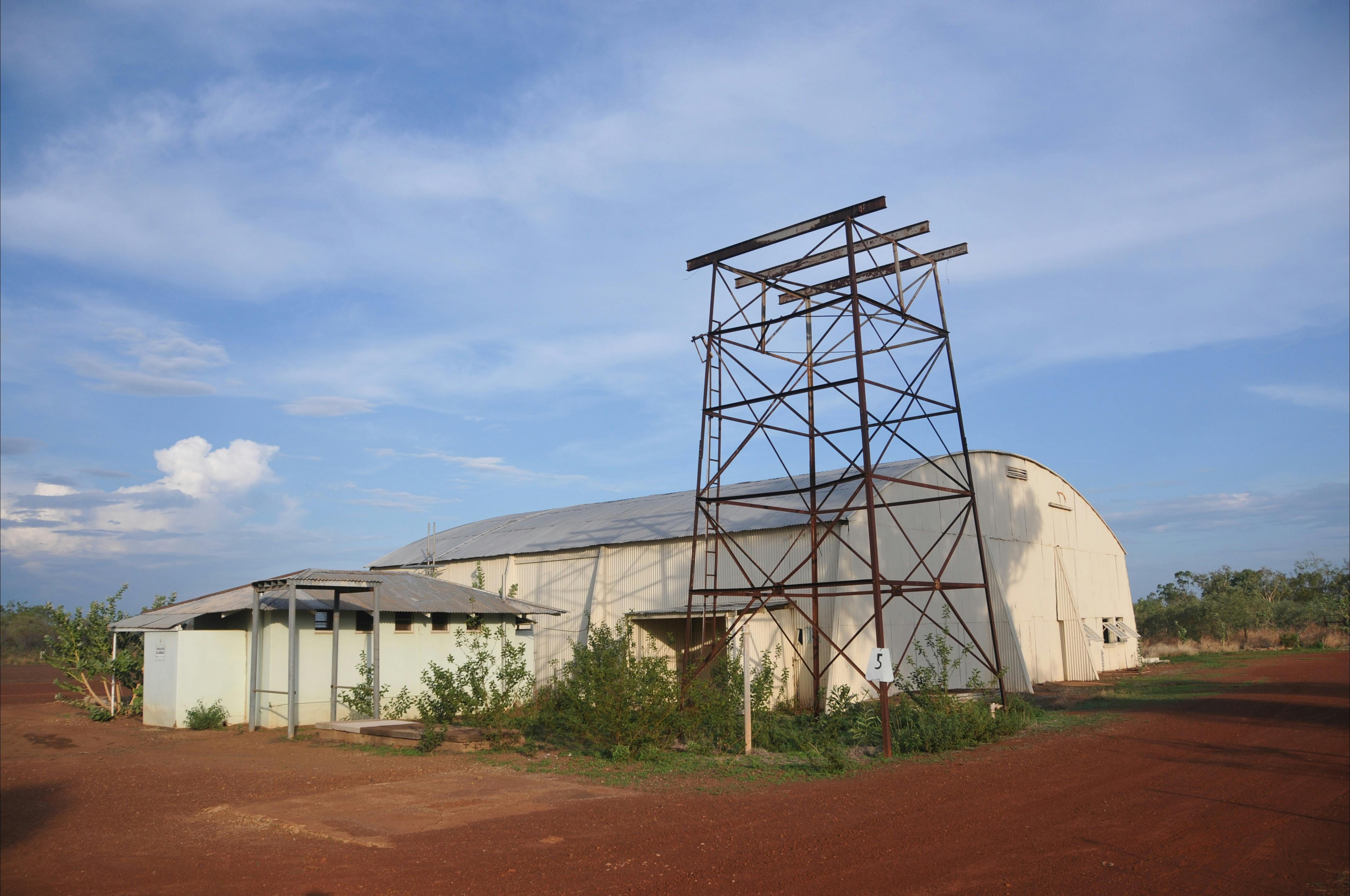The Hangar with public toilet block in the left foreground. Water tank stand on right.