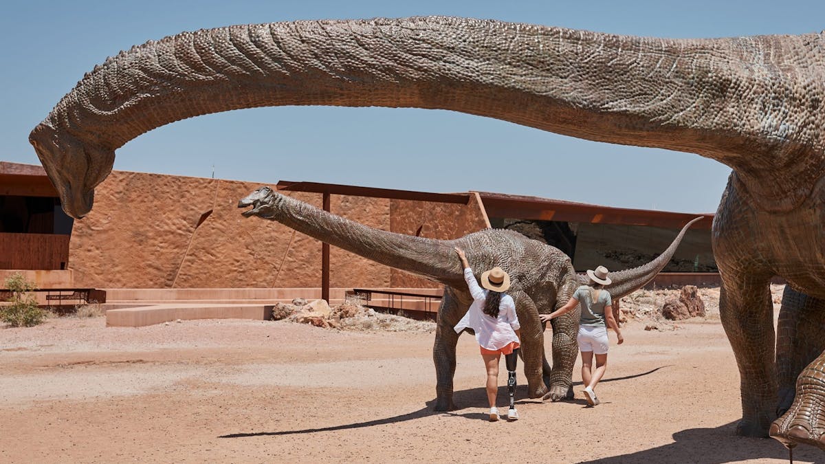 Visitors with bronze titanosaurs