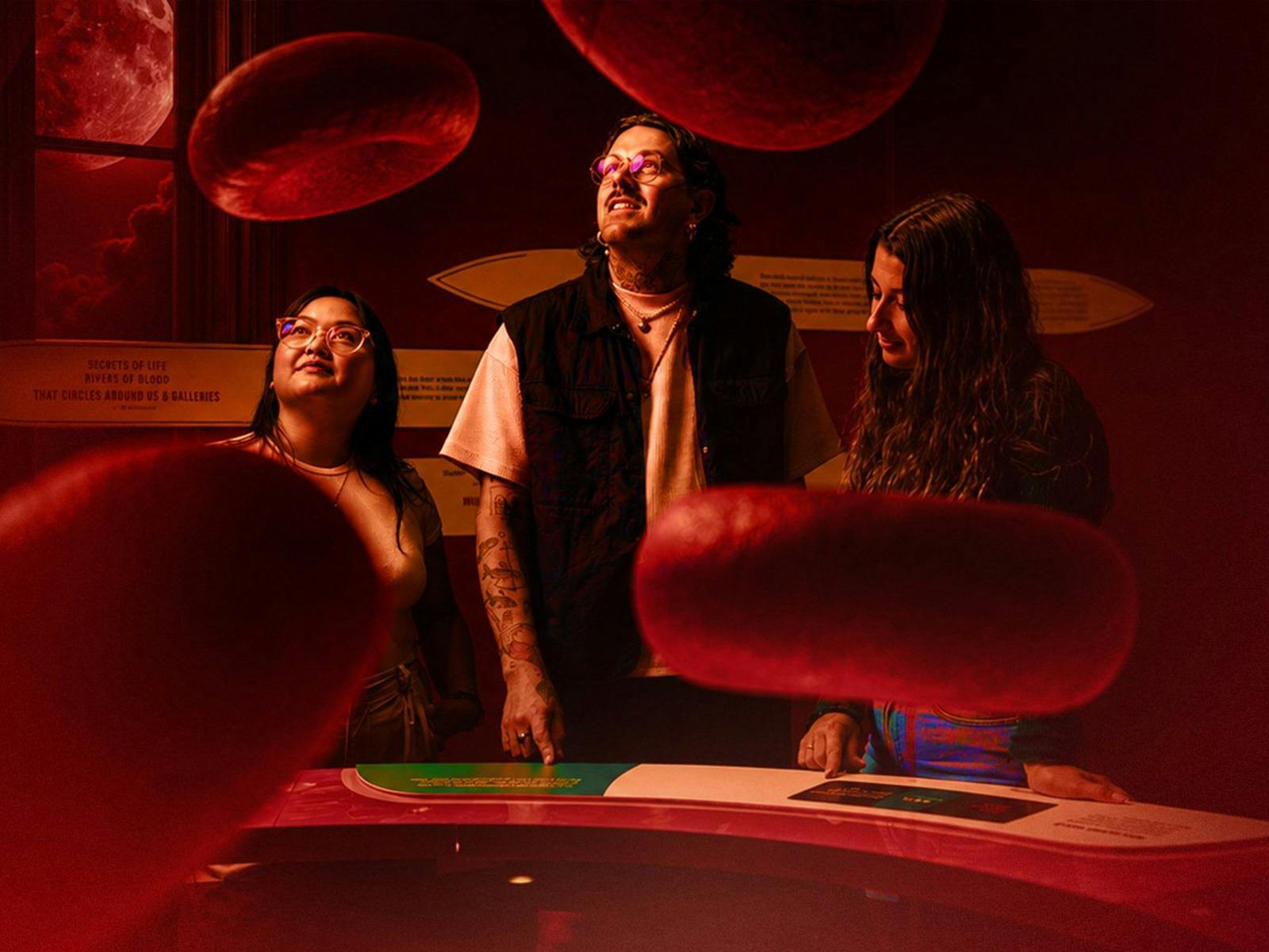 A group of friends exploring the Bloodsuckers exhibition