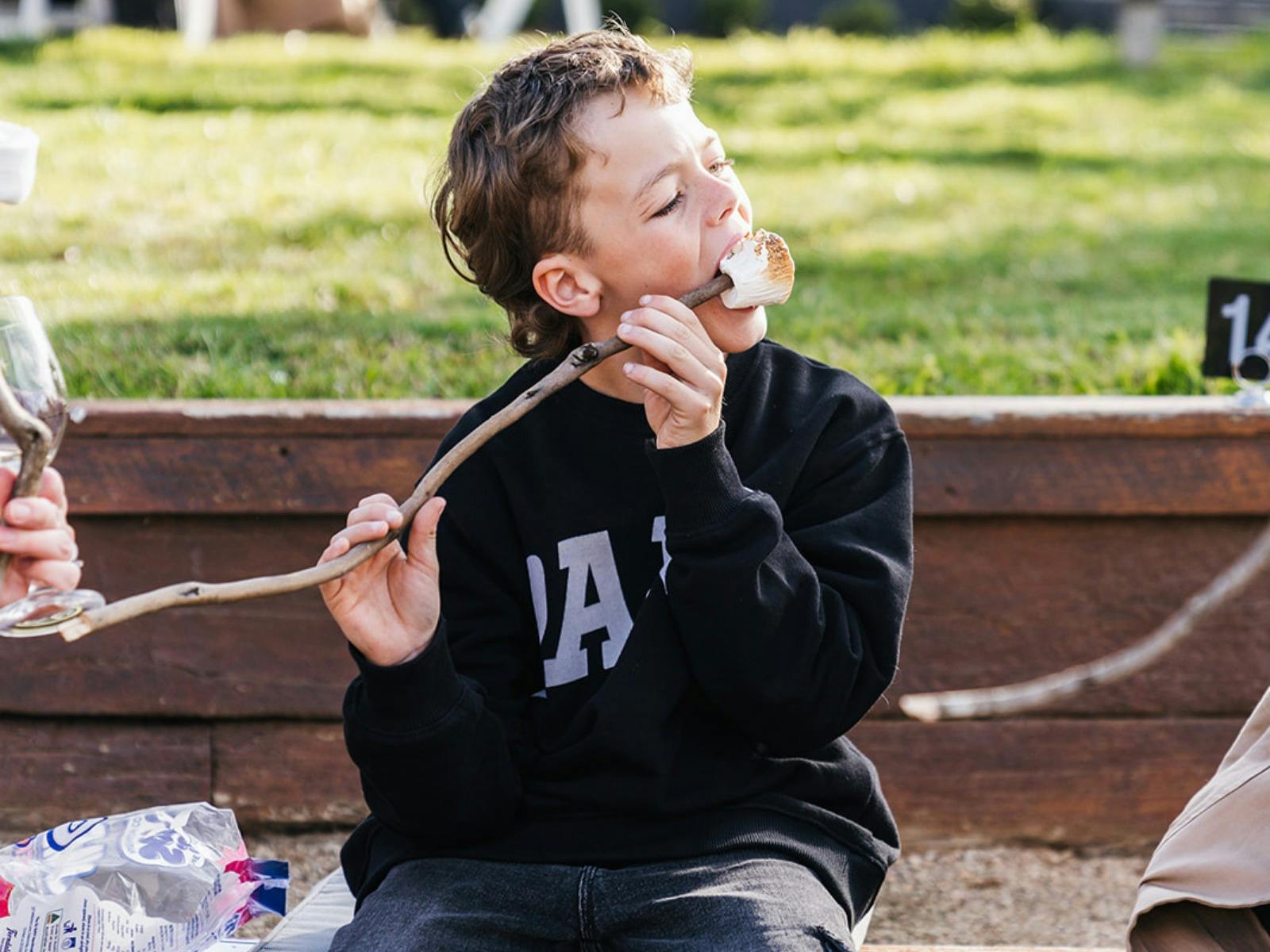 Boy eating roasted marshmallow at Stockman's Ridge Wines