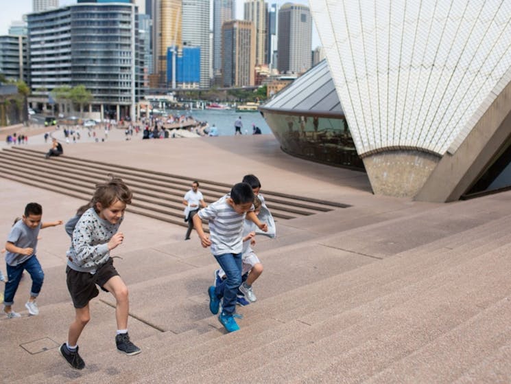 Group of kids running up the Monumental Steps of the Sydney Opera House