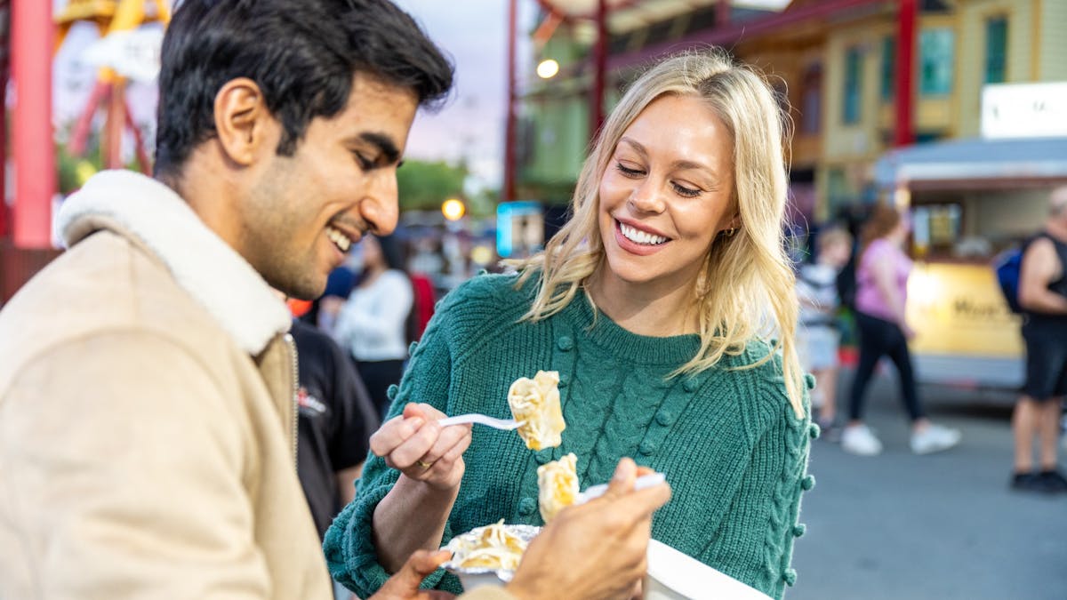 Couple eat food at night market