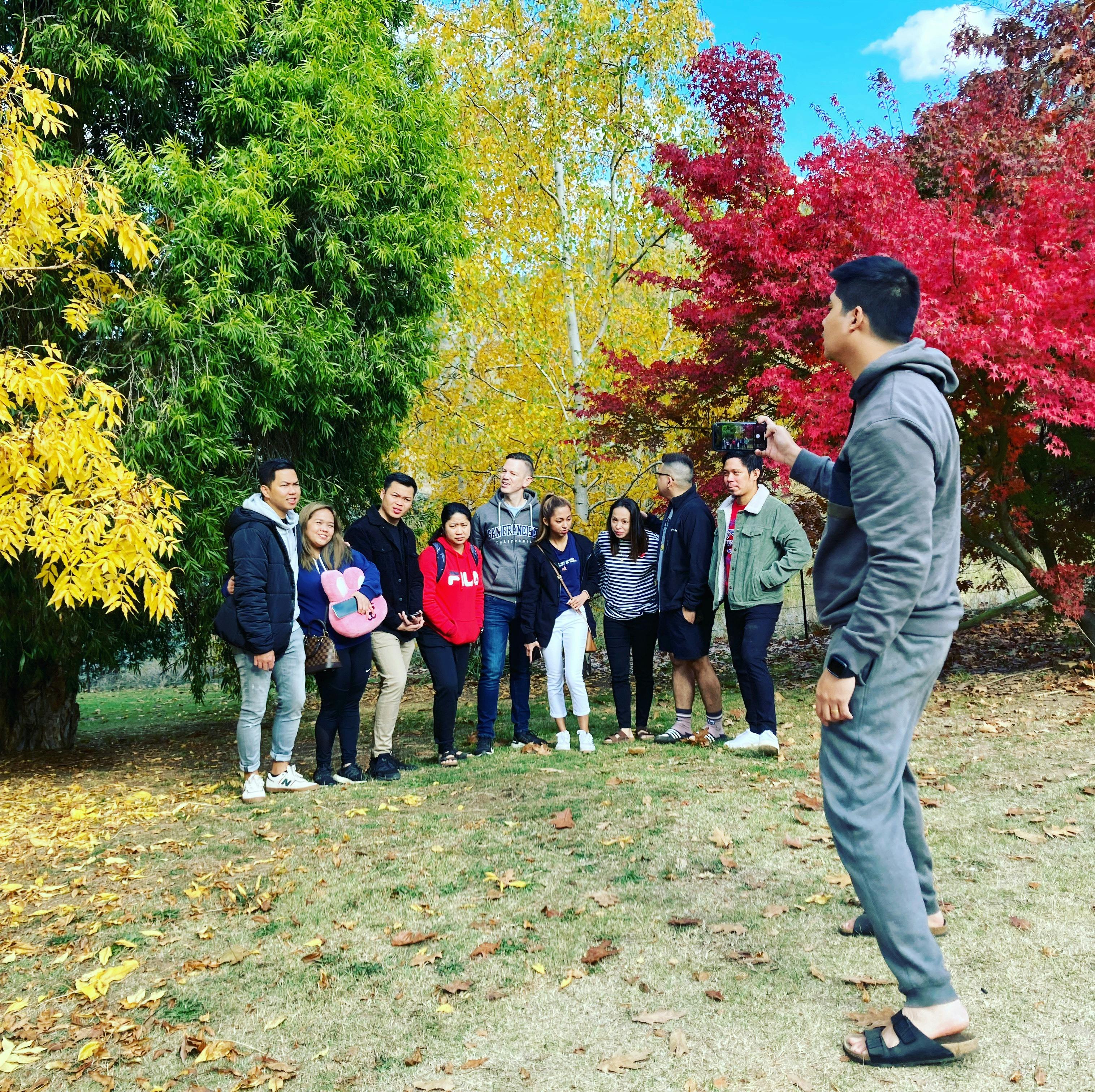 Group standing in front of tulip tree in Autumn