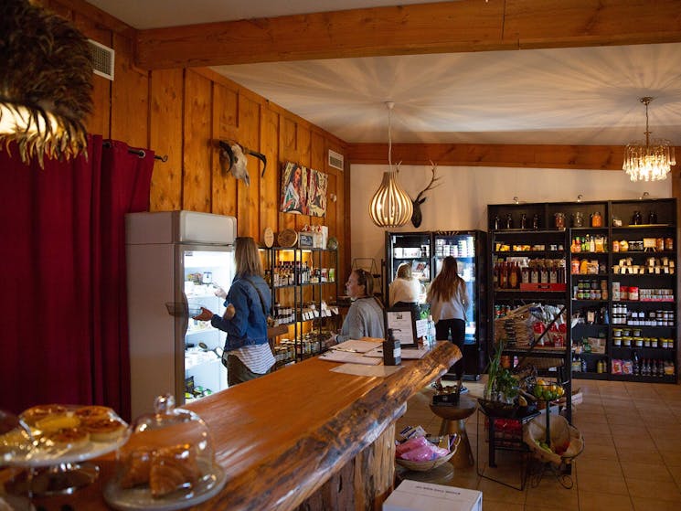 Fridges and shelves stocked with gourmet food inside providor