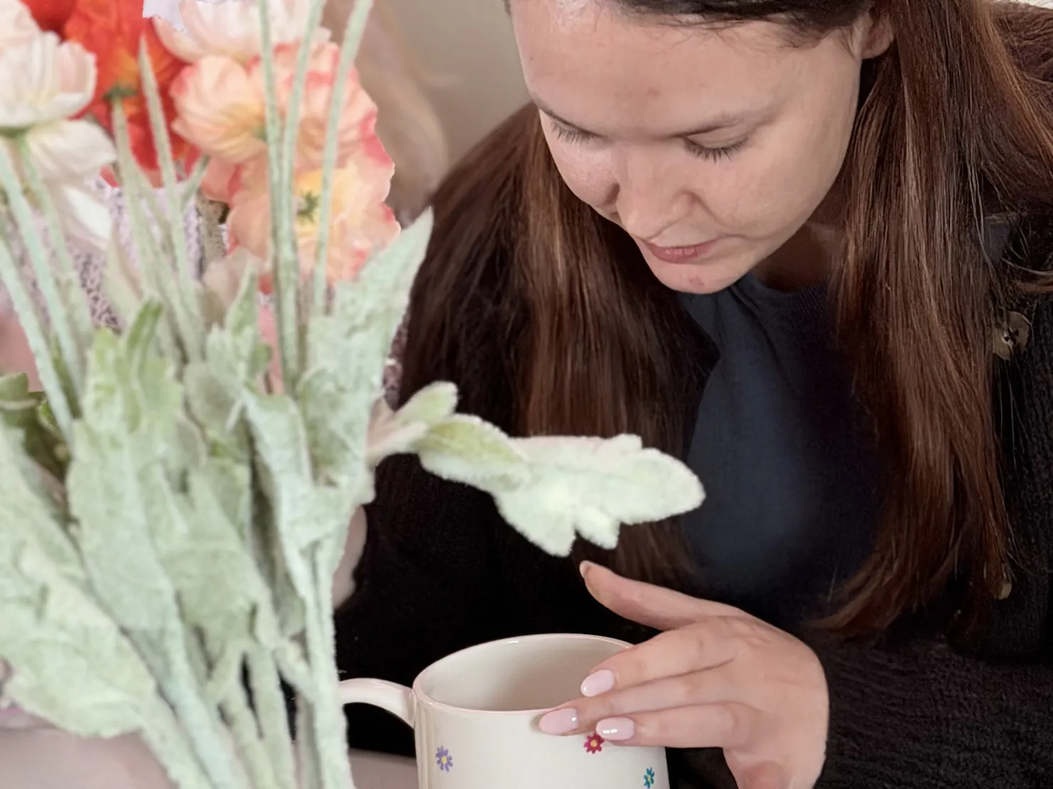 Guest hand-painting a ceramic cup at a NOA Matcha workshop