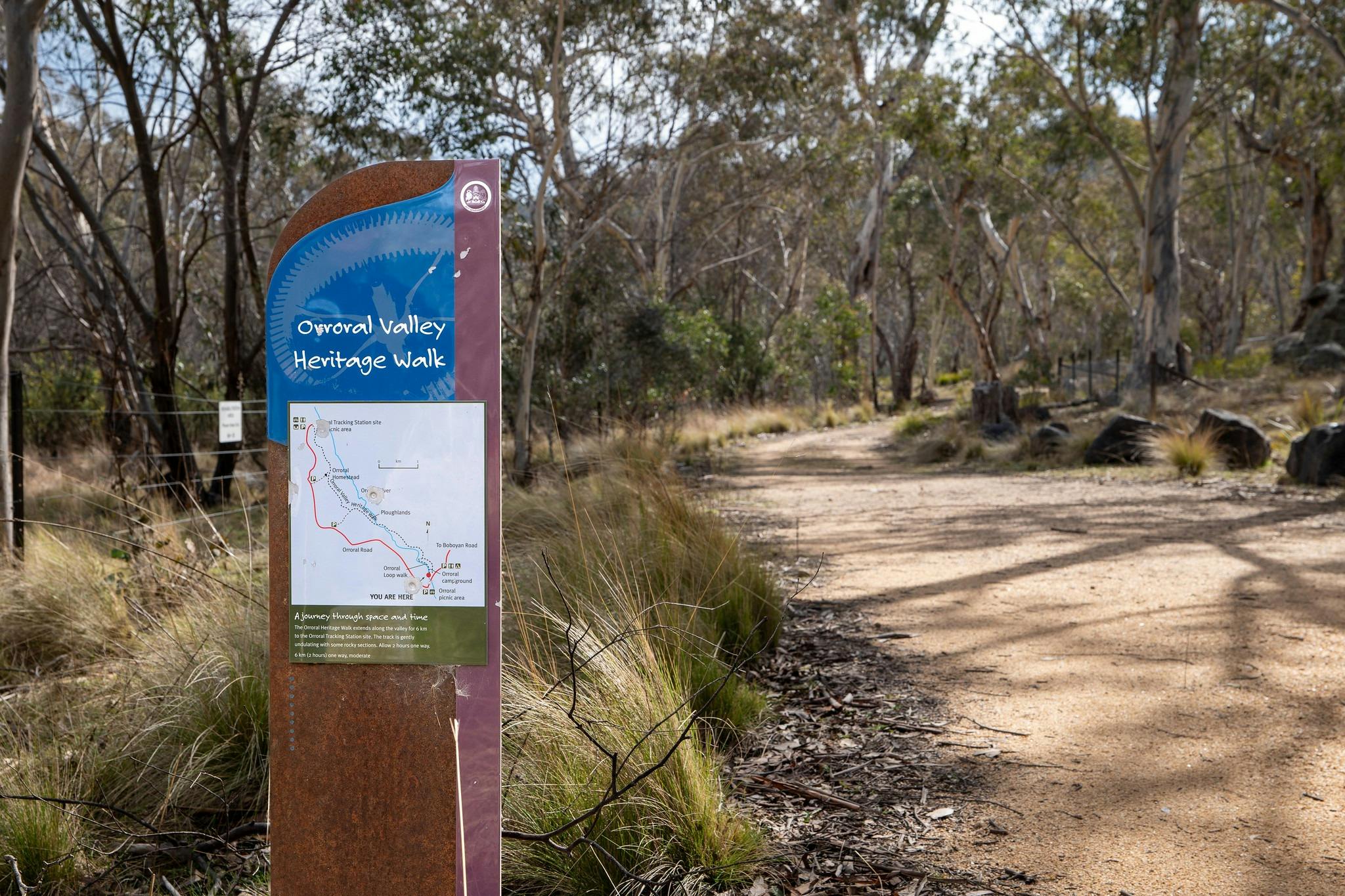 Bushland with trail signage in foreground