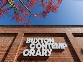 A sign on a brick wall reads Buxton Contemporary