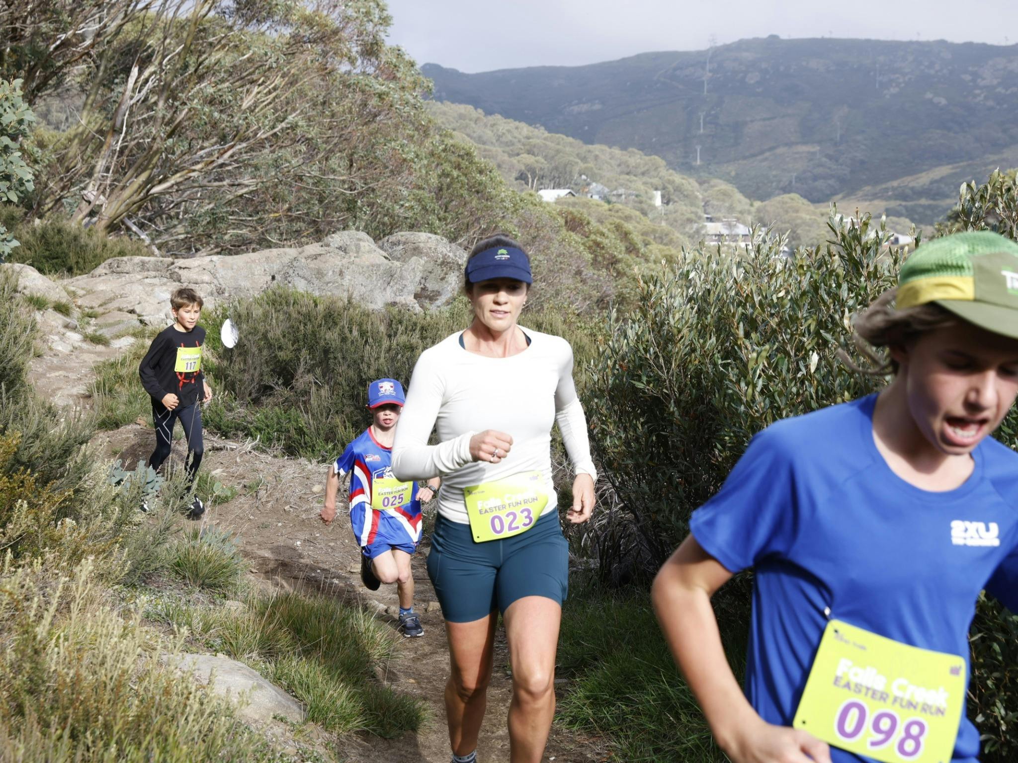 Family of 4 running the mountain trail