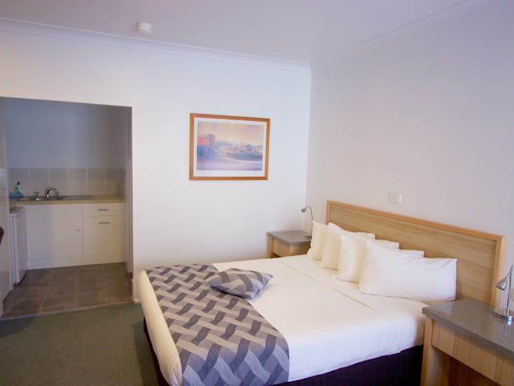 Guest room with comfortable queen bed on ground floor with kitchenette.