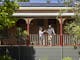 couple standing at the balcony and holding glasses of wine at The Brewer's House