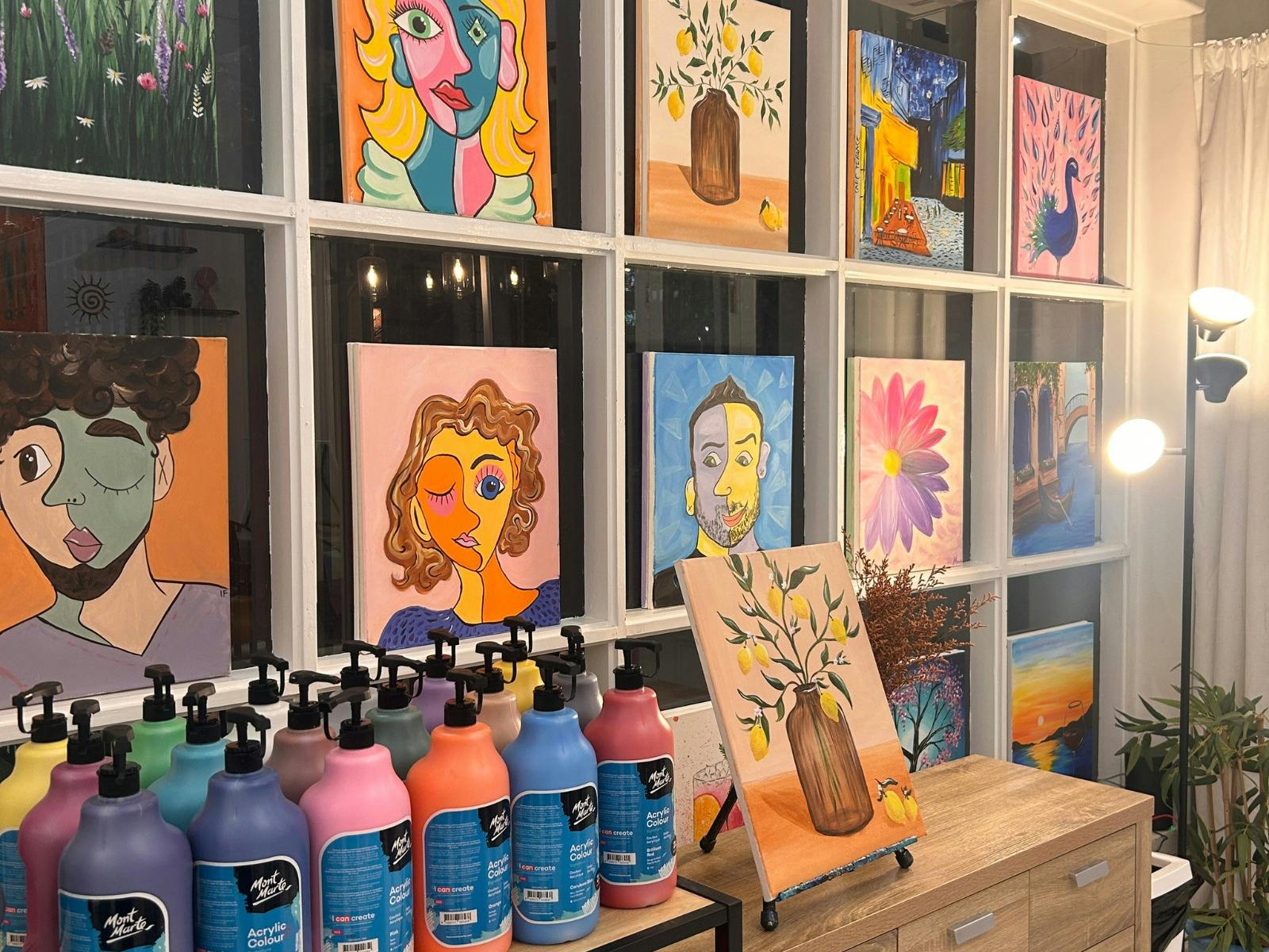 Paintelaide Studio in Adelaide City with paints and paintings setup