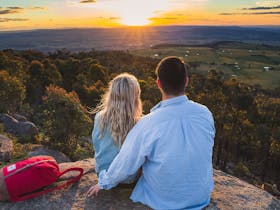 Photo of a couple enjoying sunrise at Mt Wombat