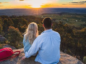 Photo of a couple enjoying sunrise at Mt Wombat