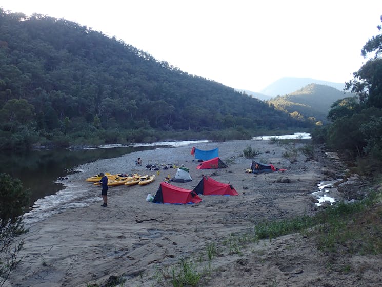 Tents are on a sandbank formed bay the snowy river