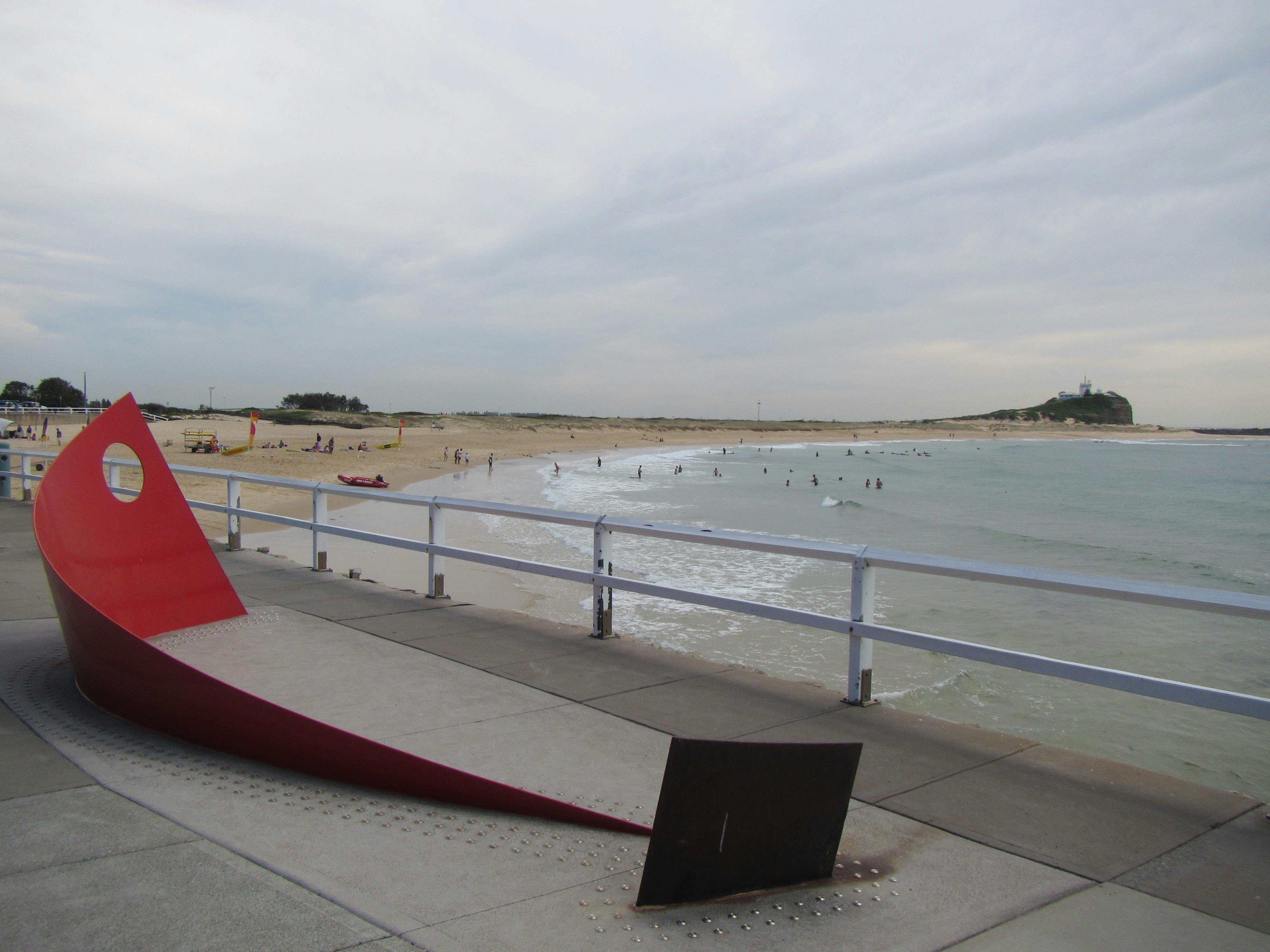 A red metal sculpture at the beach to remember the Pasha Bulka