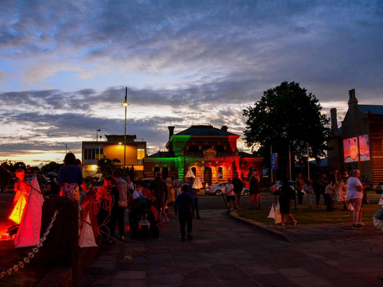 Buildings lit up, People with Lanterns
