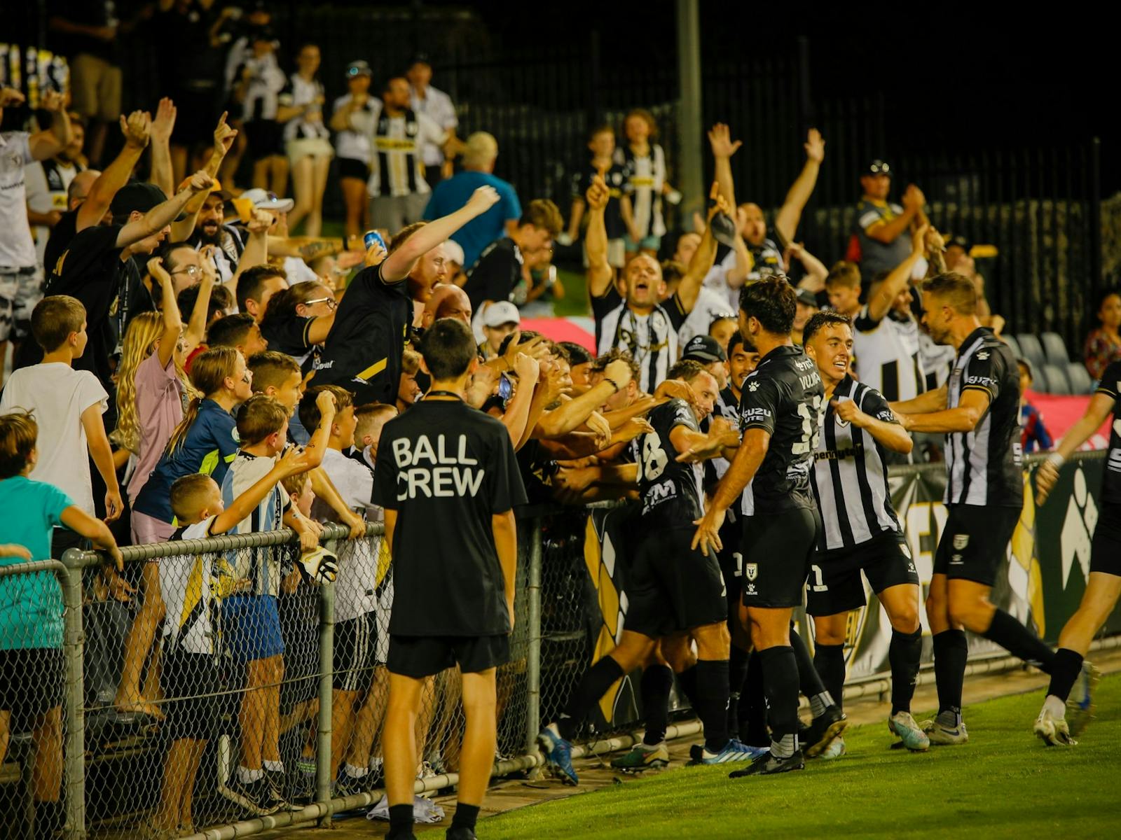 fans cheering in stadium for Macarthur Bulls FC team