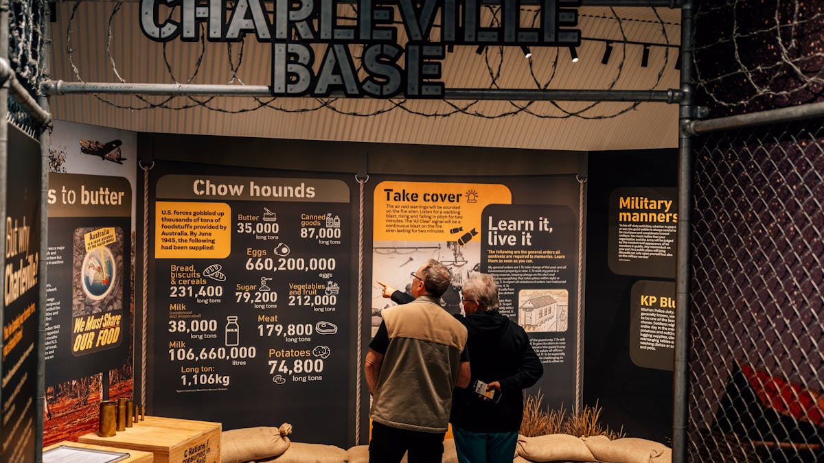 a couple inside the interactive exhibit pointing at a display