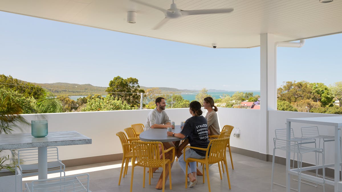 Guests sit around table looking at the view