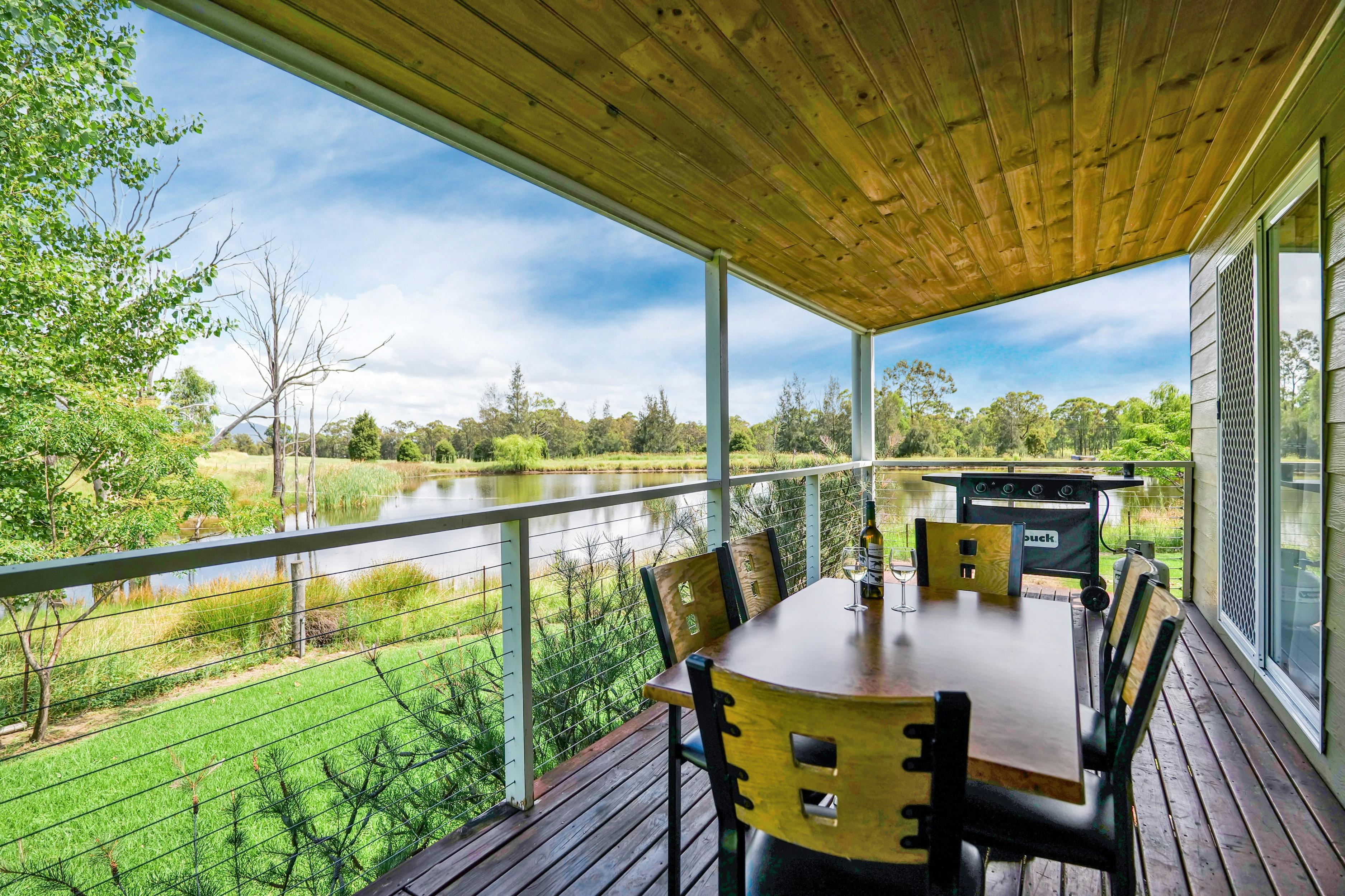 Looking towards the duck pond from the veranda of a Waterview Cottage