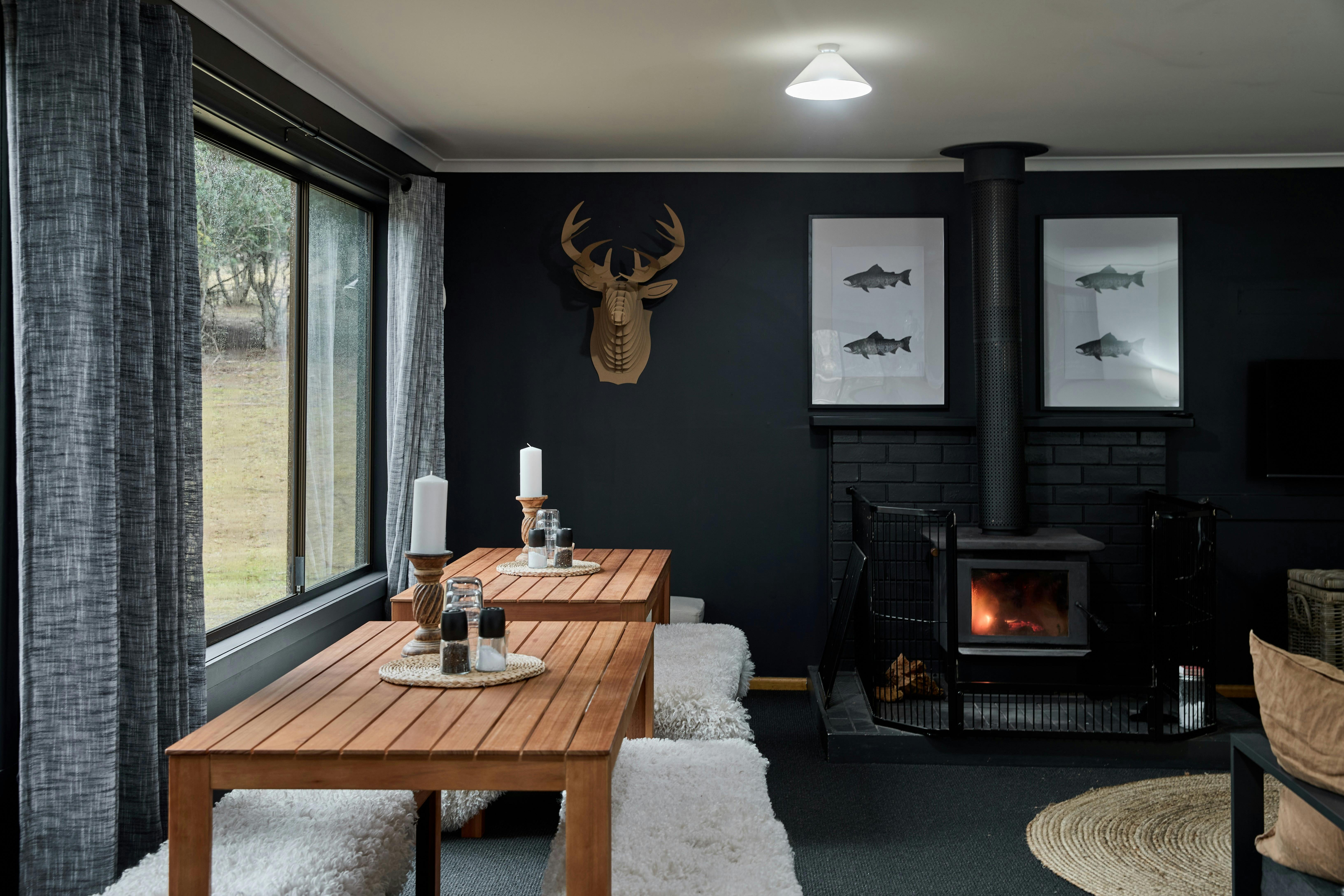 2 large dining tables within open plan lounge. Wood fire lit