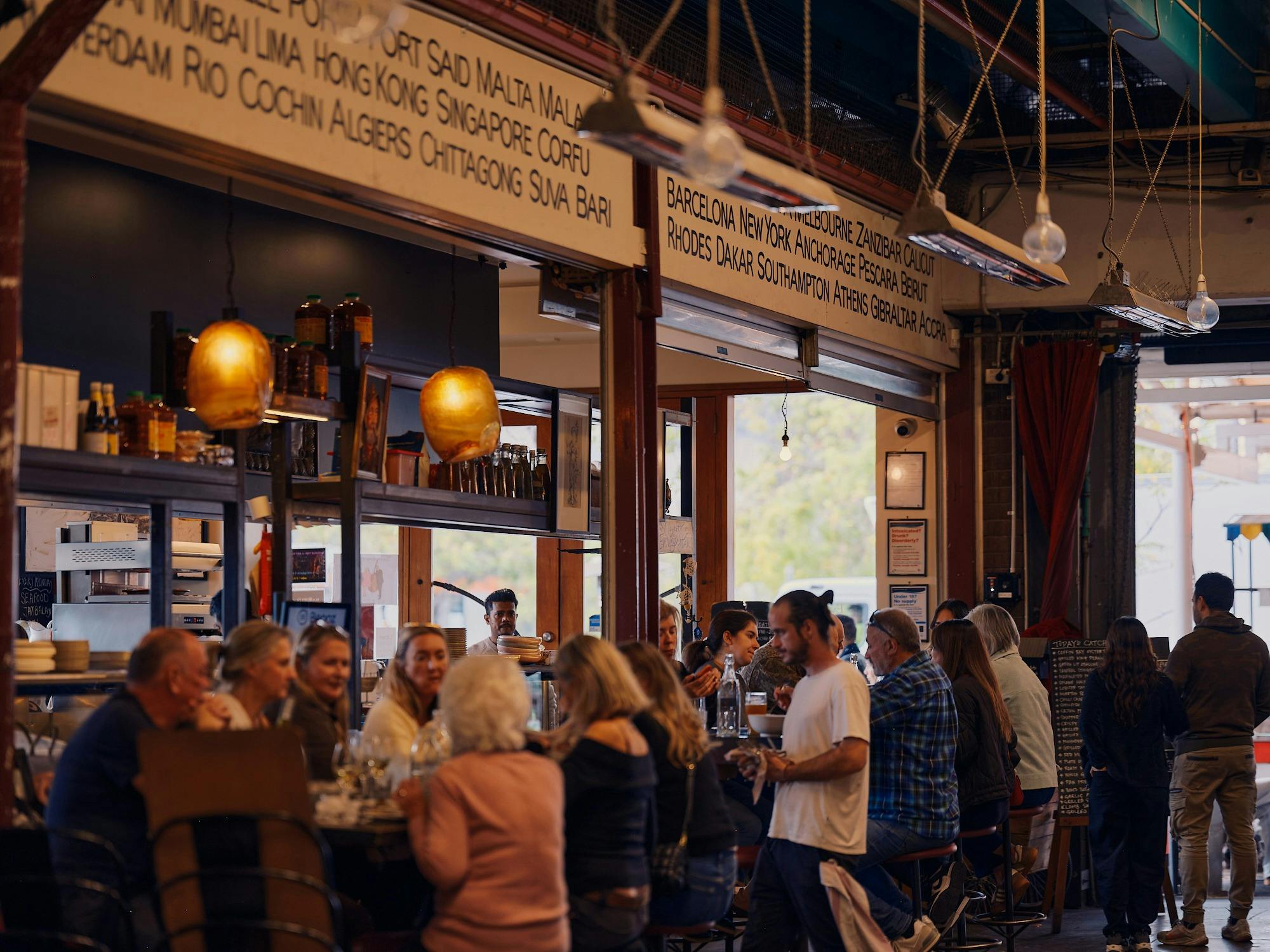 Diners enjoying food and drinks inside Claypots Evening Star.