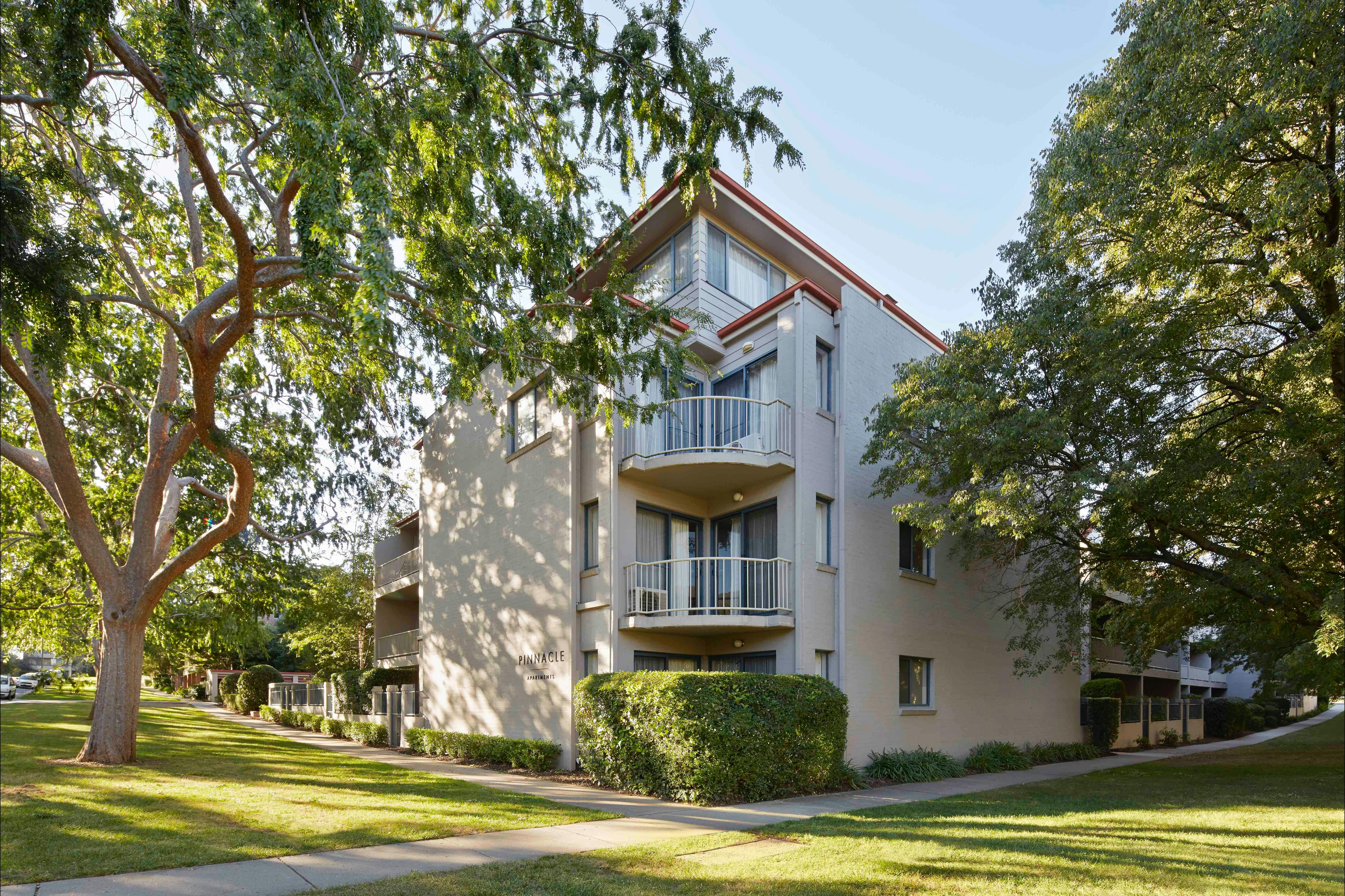 Hotel exterior surrounded by big leafy trees