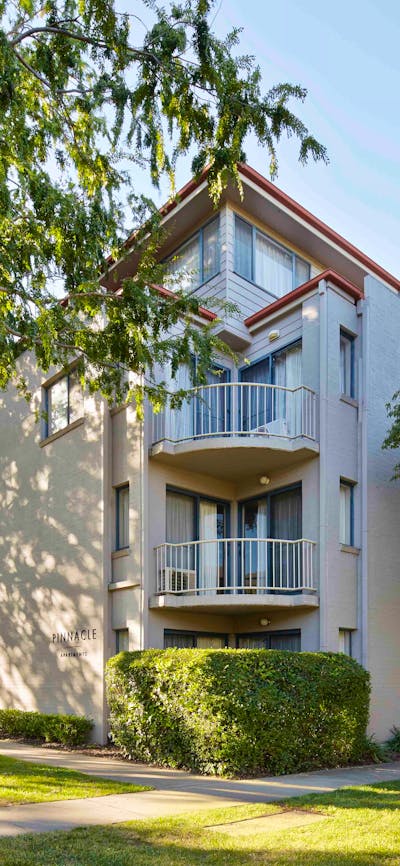 Hotel exterior surrounded by big leafy trees