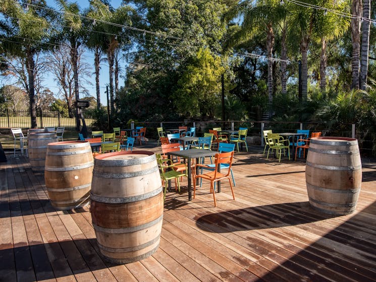 Deck area with outside furniture and wine barrels