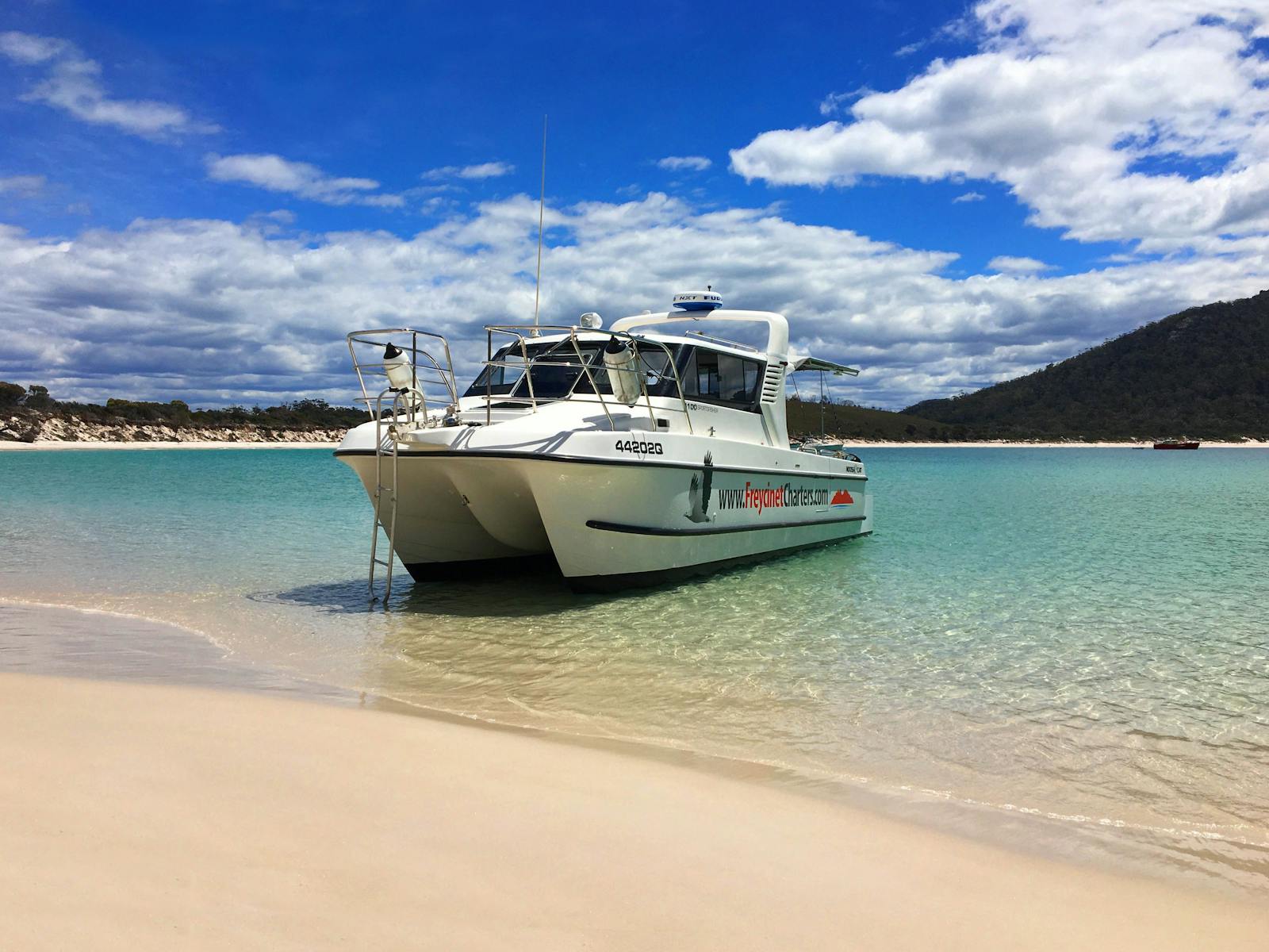 Landing on Wineglass Bay, the water is crystalline the sand is pearl-like