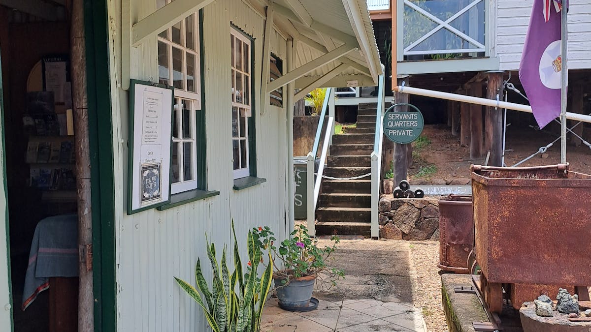 front wall, door and windows of a corrugated iron and timber two story building, built in 1884
