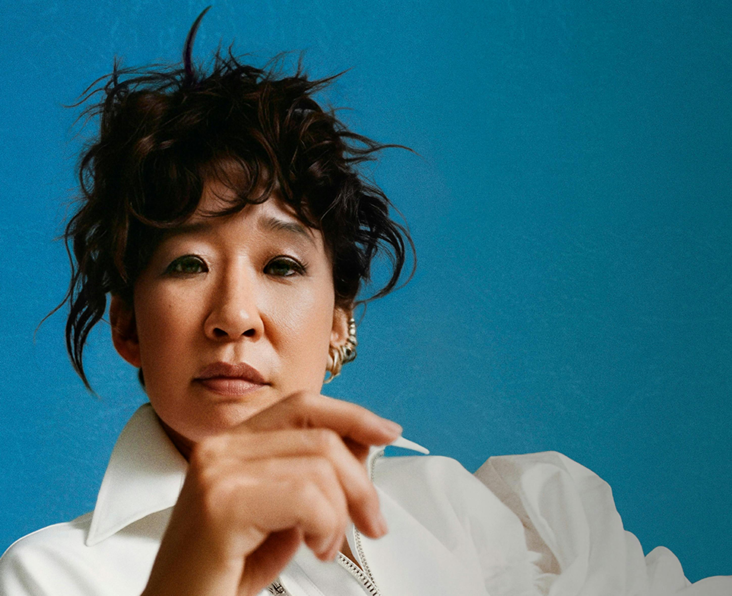 Sandra Oh in front of a blue background