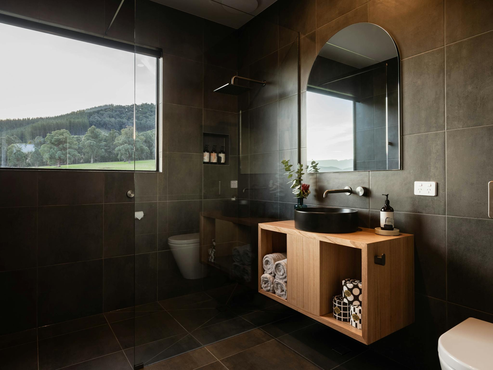 Bathroom with large window in shower with mountain views