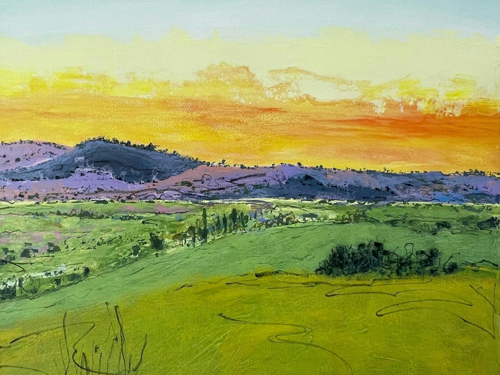 Sunset painting - green rolling hills, purple haze mountains and orange/yellow sunset