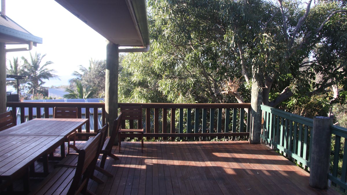 Outdoor dining for 12 on the covered timber deck with views to the ocean