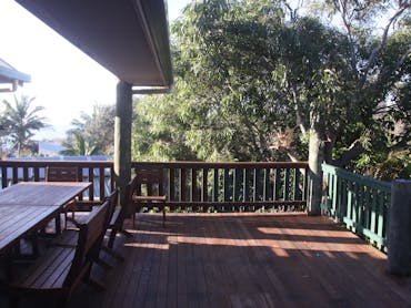 Outdoor dining for 12 on the covered timber deck with views to the ocean