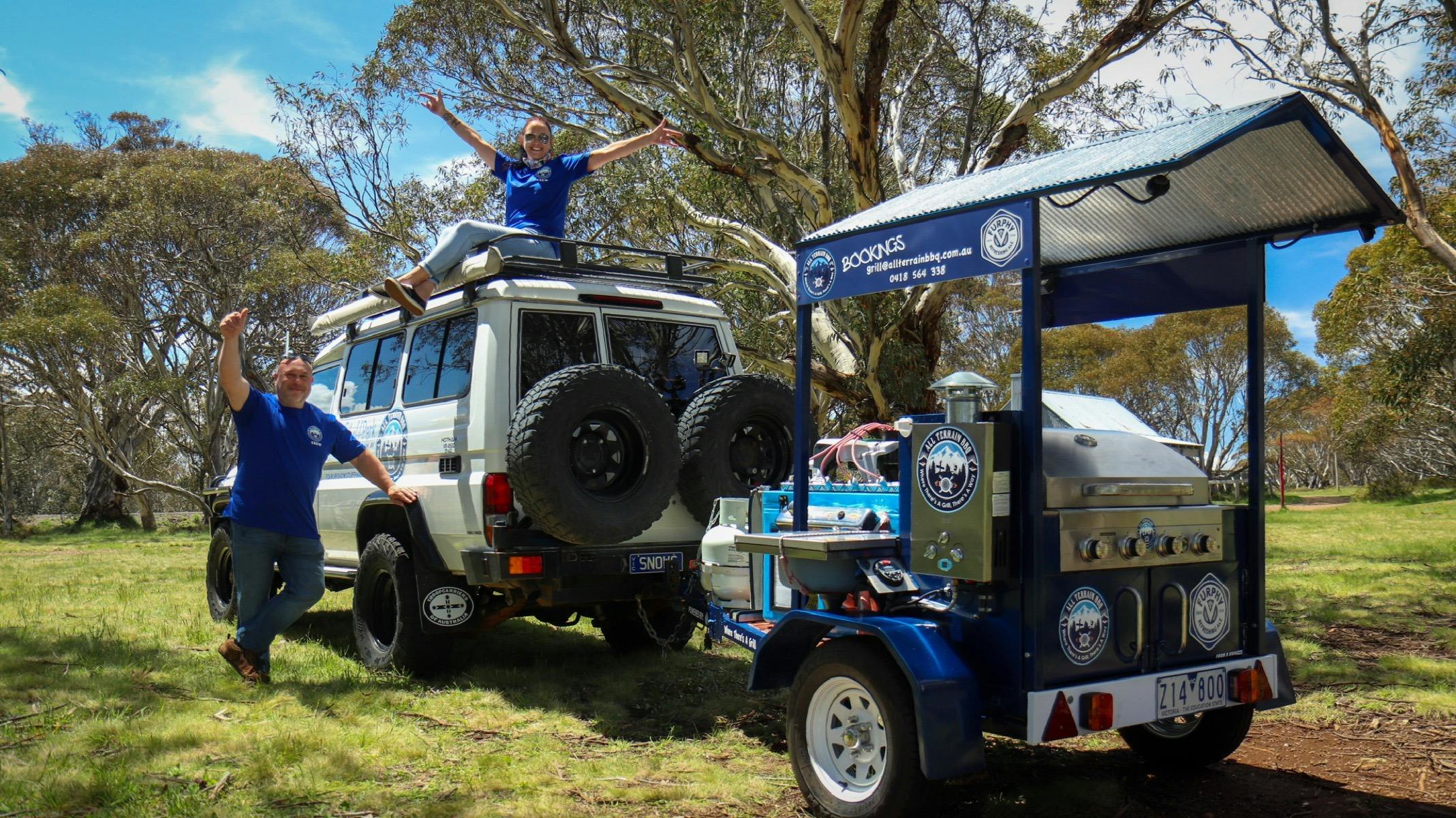 Grill trailer with two people posing for the photo