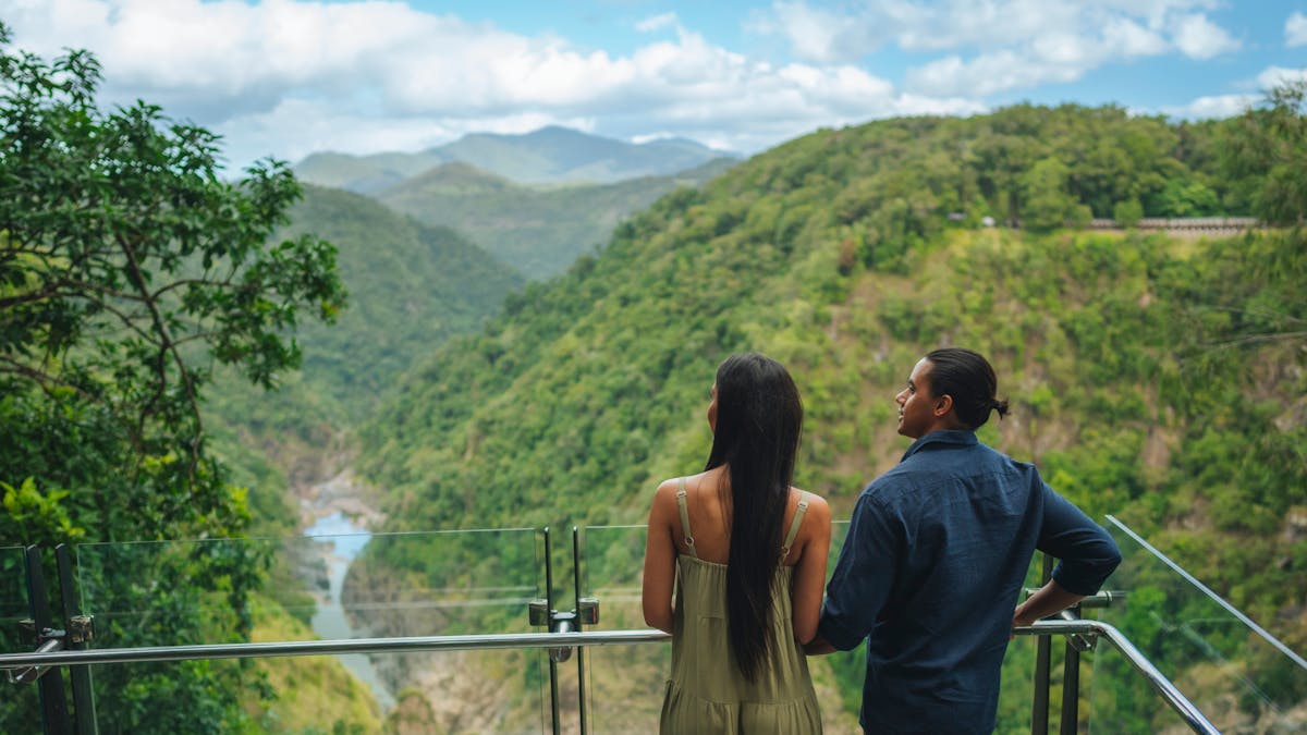 Man and lady facing away from the camera looking at the view in front of them of the barron gorge