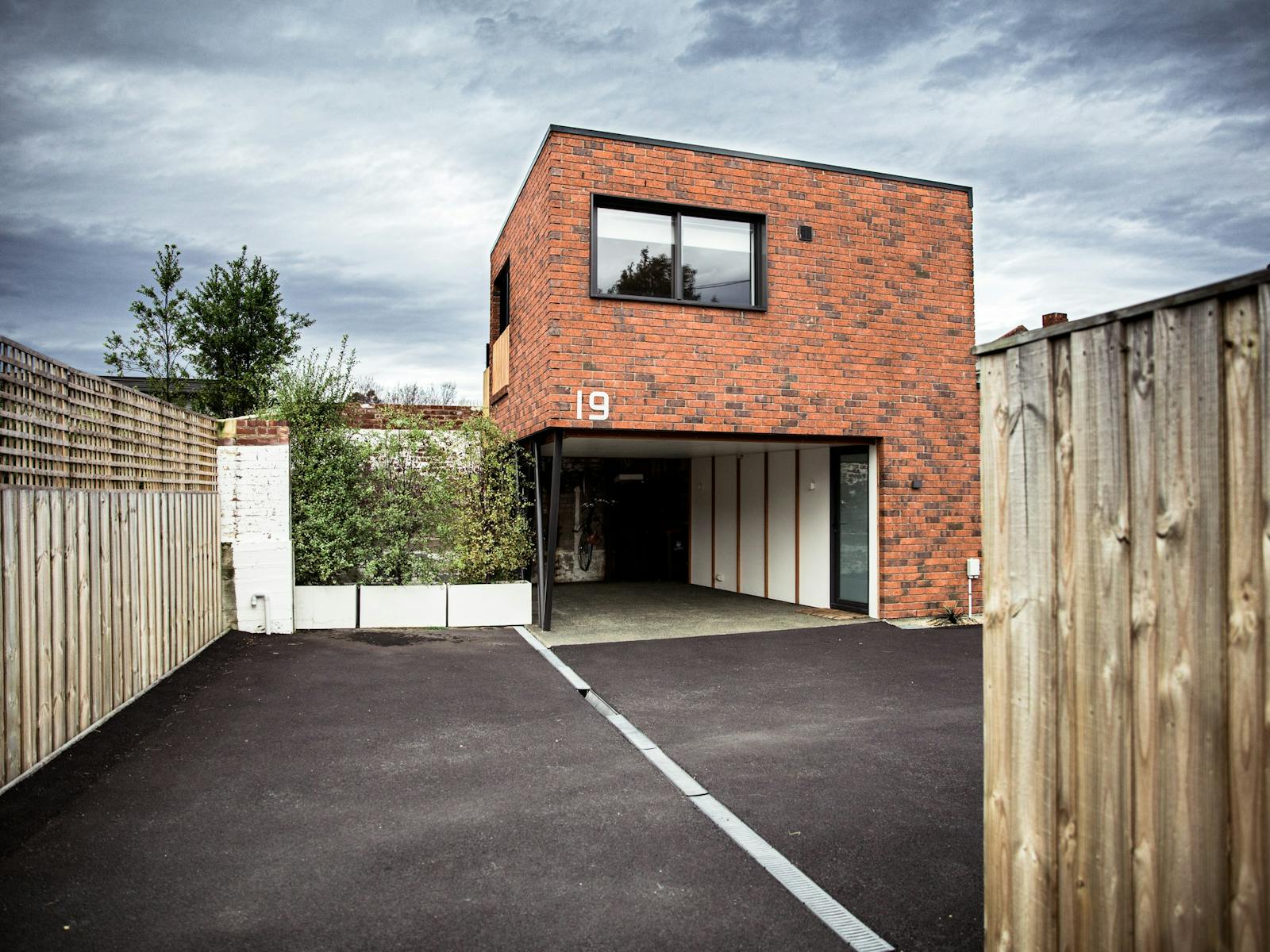 Photo shows The Loft at Soho and carport from the driveway.