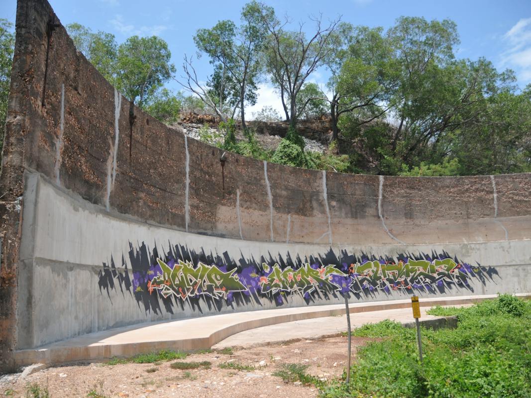 Oil tank wall with graffiti artwork to face of new stabilising wall. Cracks have been repaired.