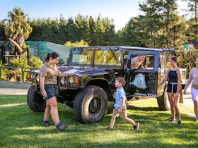 Family and zoo guide with a Hummer, a vehicle used for night tours within the national zoo