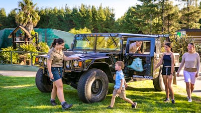 Family and zoo guide with a Hummer, a vehicle used for night tours within the national zoo