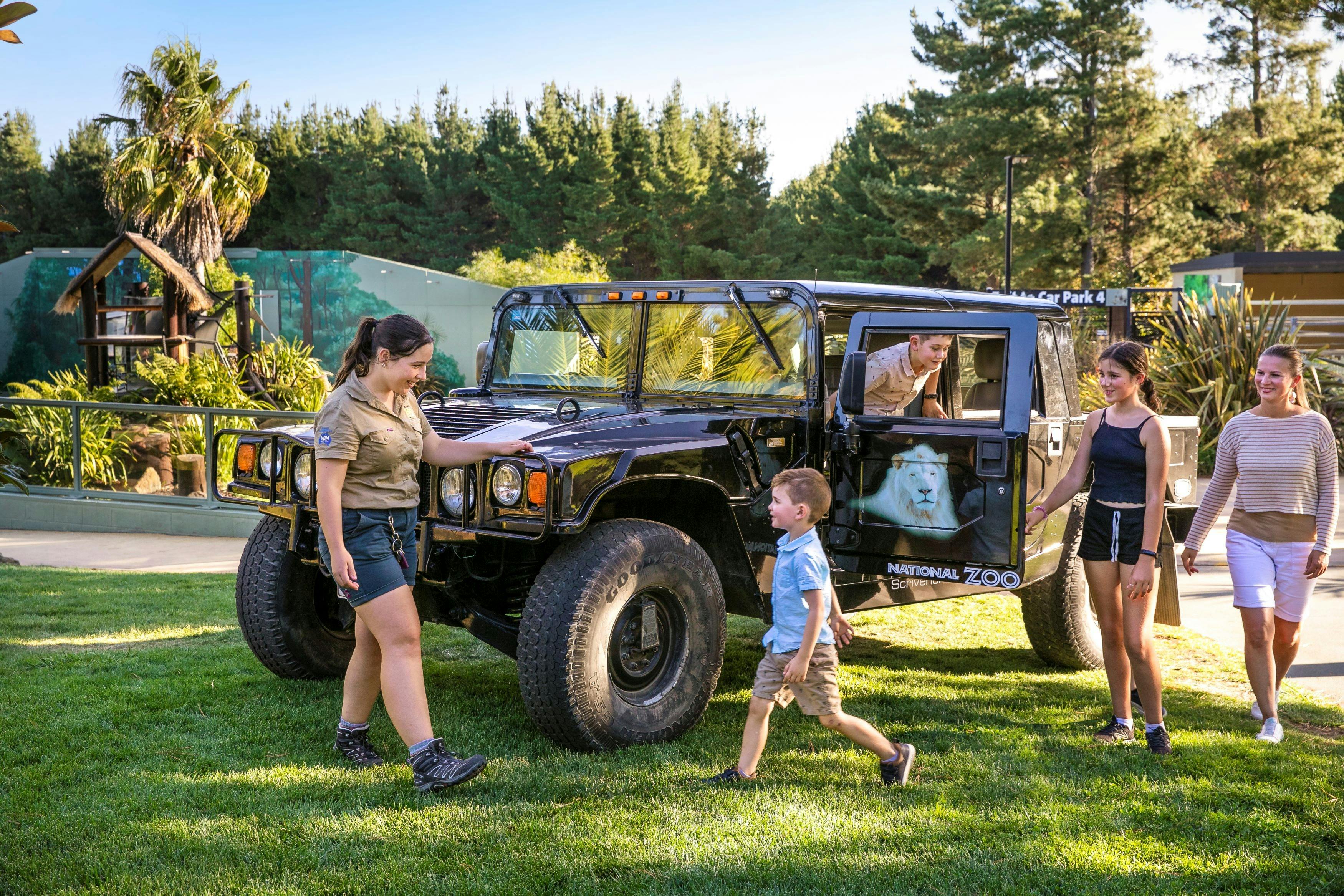 Family and zoo guide with a Hummer, a vehicle used for night tours within the national zoo