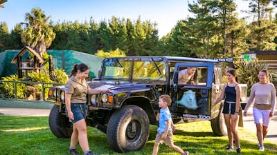 Family and zoo guide with a Hummer, a vehicle used for night tours within the national zoo