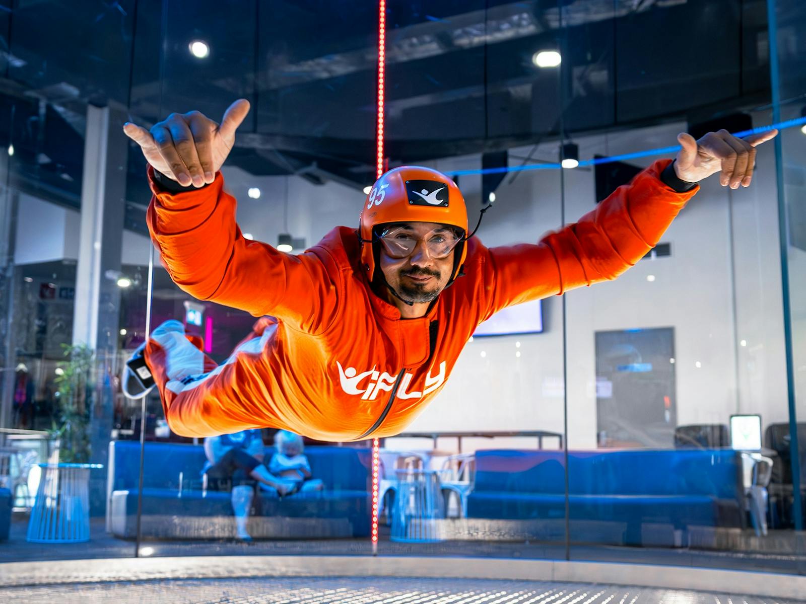 Adult male throws a shakka while flying