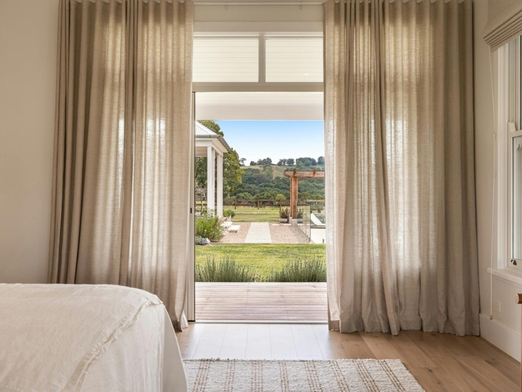 King bedroom with garden outlook and views across the Byron Bay Hinterland