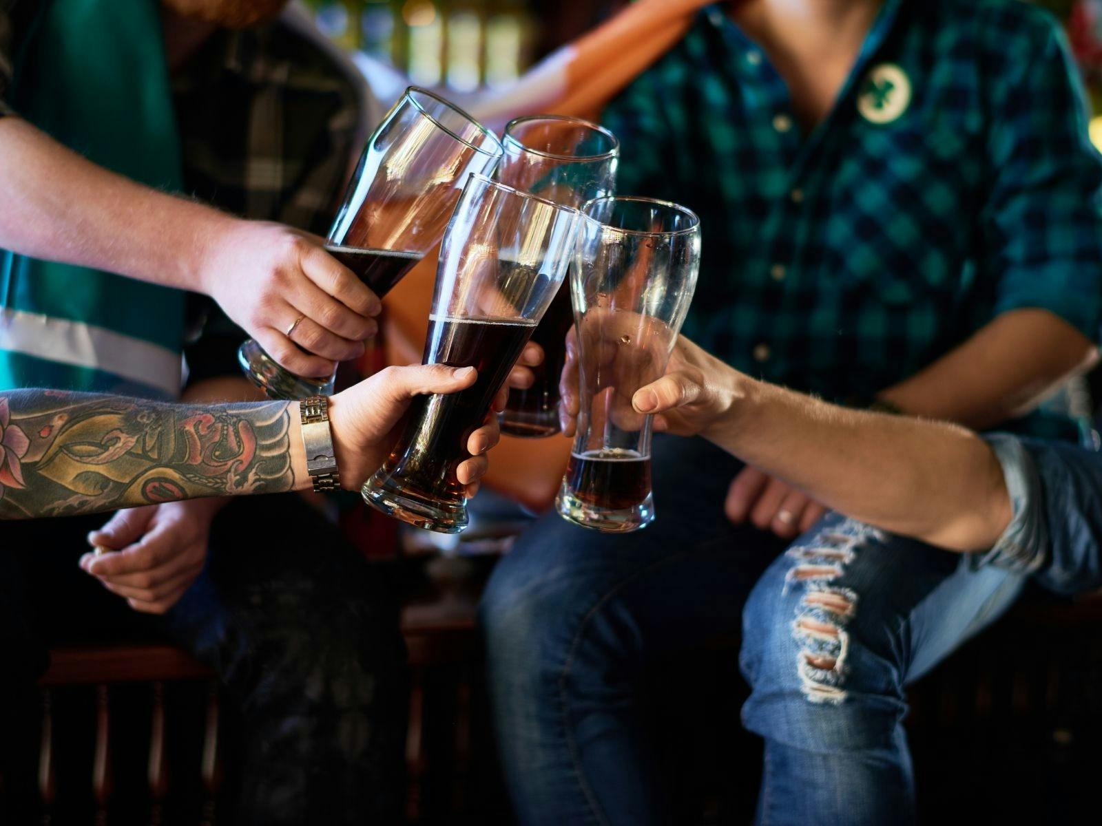 Hands holding beers, cheersing