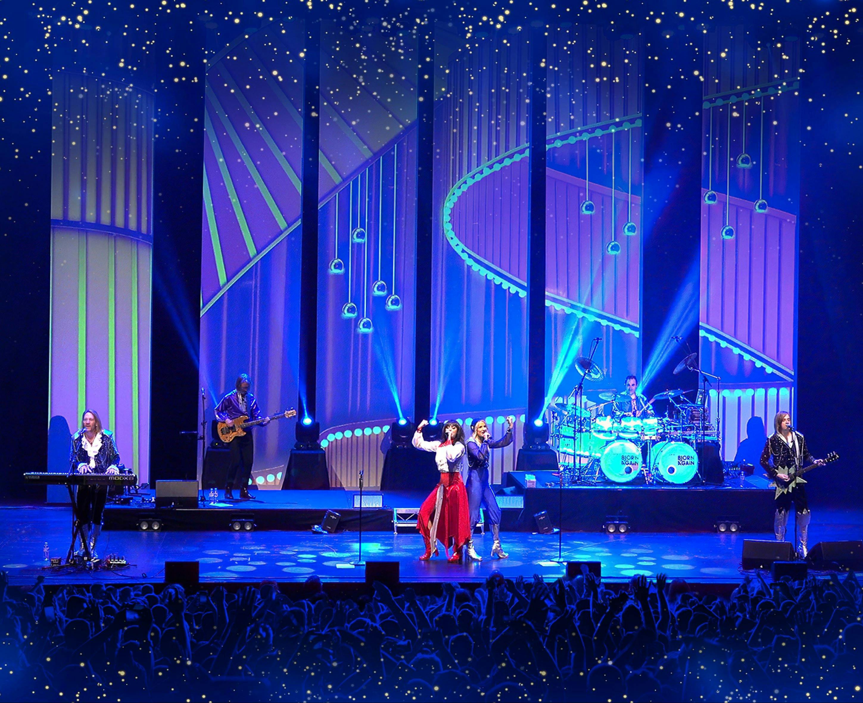 stage with two singers dressed in red and blue, two guitar players, a keyboard player and a drummer